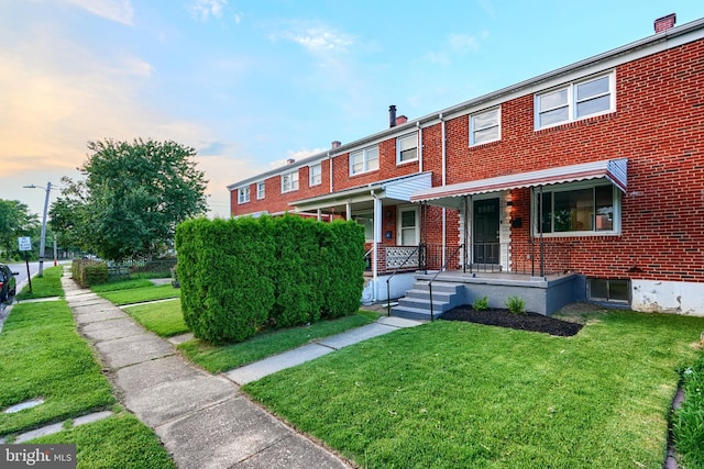 267 Southeastern Ter, Baltimore, MD 21221 - townhome / multi-family property with brick siding and a front yard