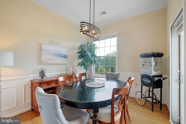 7 Booth St Unit 402, Gaithersburg, MD 20878 - dining area with crown molding, light wood-style flooring, and a wainscoted wall