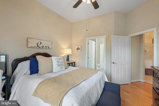 7 Booth St Unit 402, Gaithersburg, MD 20878 - bedroom featuring light wood-style floors, connected bathroom, ceiling fan, and a towering ceiling