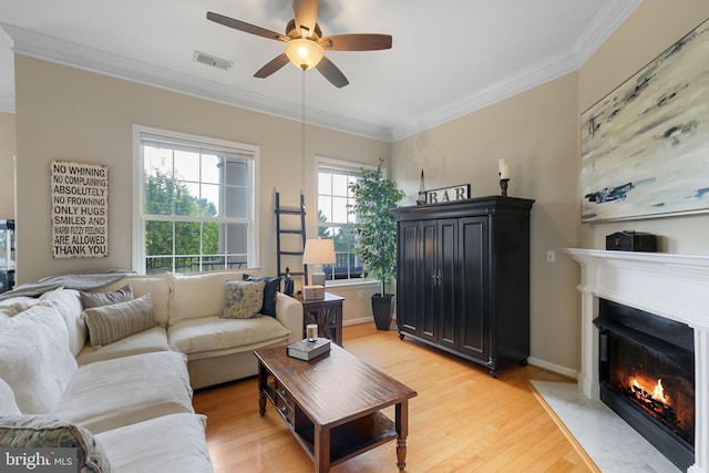 7 Booth St Unit 402, Gaithersburg, MD 20878 - living area featuring light wood finished floors, ceiling fan, crown molding, and a fireplace with flush hearth