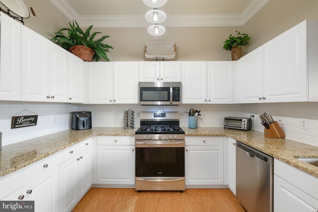 7 Booth St Unit 402, Gaithersburg, MD 20878 - kitchen with appliances with stainless steel finishes, ornamental molding, white cabinetry, backsplash, and light wood-style floors