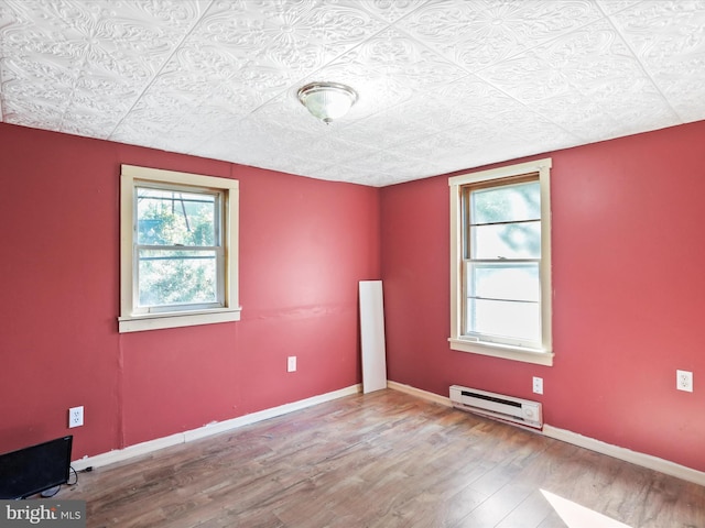 679 Winchester Grade Rd, Berkeley Springs, WV 25411 - spare room with a baseboard radiator and wood finished floors