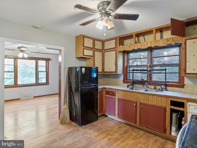 679 Winchester Grade Rd, Berkeley Springs, WV 25411 - kitchen featuring freestanding refrigerator, a ceiling fan, light wood-style floors, and decorative backsplash