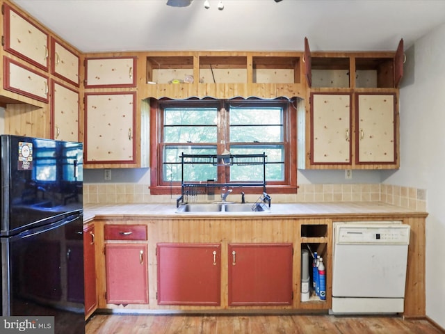 679 Winchester Grade Rd, Berkeley Springs, WV 25411 - kitchen with freestanding refrigerator, dishwasher, tile counters, and light wood-style floors