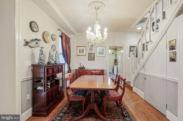 1117 S Carolina Ave SE, Washington, DC 20003 - dining space featuring a chandelier, light wood-style flooring, stairs, and recessed lighting