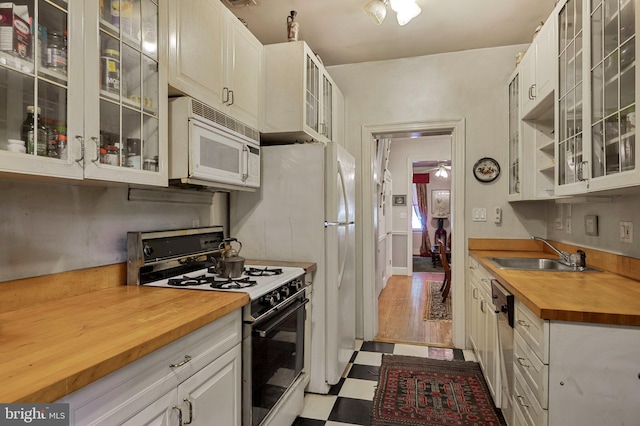 1117 S Carolina Ave SE, Washington, DC 20003 - kitchen with white appliances, butcher block counters, tile patterned floors, glass insert cabinets, and a ceiling fan
