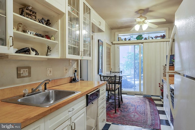 1117 S Carolina Ave SE, Washington, DC 20003 - kitchen featuring freestanding refrigerator, butcher block counters, stainless steel dishwasher, a ceiling fan, and glass insert cabinets