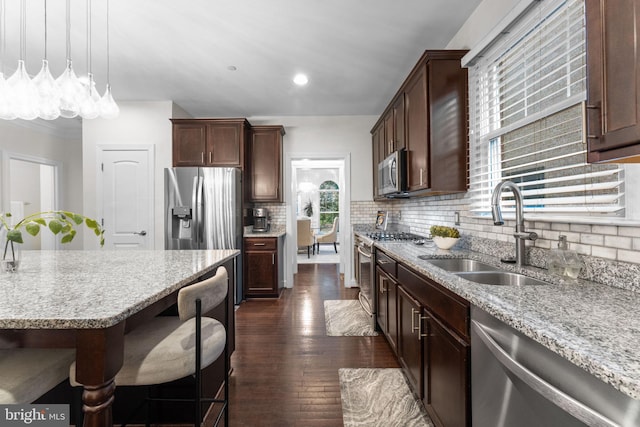 6006 New Hampshire Ave NE, Washington, DC 20011 - kitchen featuring appliances with stainless steel finishes, dark wood finished floors, tasteful backsplash, light stone countertops, and recessed lighting