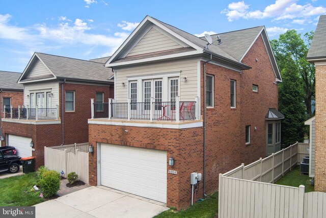 6006 New Hampshire Ave NE, Washington, DC 20011 - view of front of property with an attached garage, a balcony, concrete driveway, and brick siding