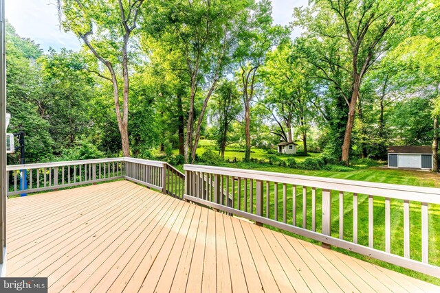 7920 Old Falls Rd, Mclean, VA 22102 - deck featuring a yard, view of scattered trees, and a storage shed