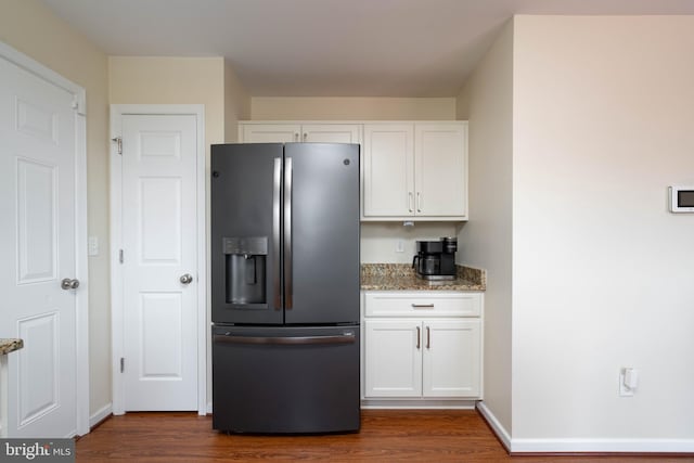 715 Dairy Dr, Middletown, DE 19709 - kitchen with stainless steel fridge, dark wood finished floors, light stone countertops, and white cabinets