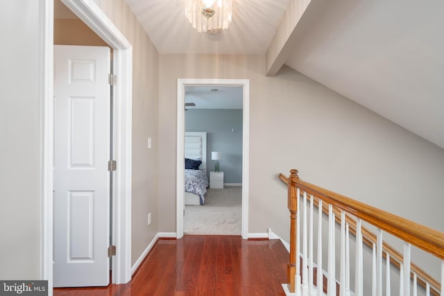 715 Dairy Dr, Middletown, DE 19709 - corridor featuring dark wood-style flooring, an upstairs landing, and a chandelier