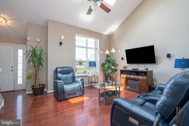 715 Dairy Dr, Middletown, DE 19709 - living area featuring a ceiling fan, a glass covered fireplace, wood finished floors, and high vaulted ceiling
