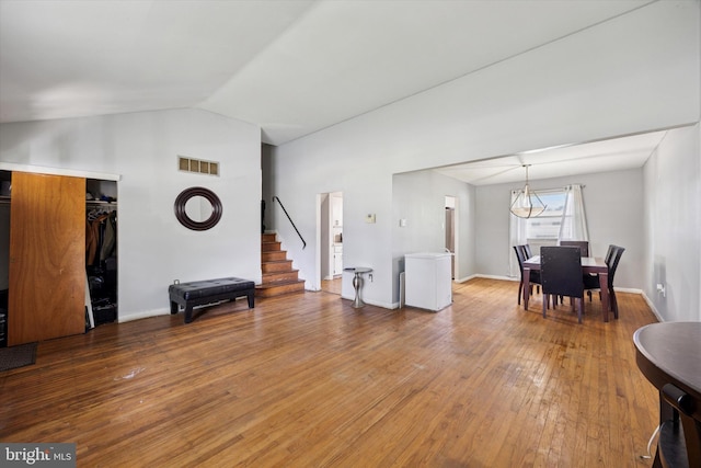 5614 Birch Ave, Pennsauken, NJ 08109 - living room featuring lofted ceiling, stairway, light wood finished floors, and a chandelier