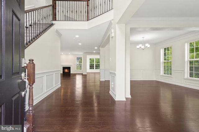 2602 Lady Grove Rd, Bowie, MD 20721 - foyer entrance featuring a decorative wall, hardwood / wood-style floors, a chandelier, ornamental molding, and a warm lit fireplace