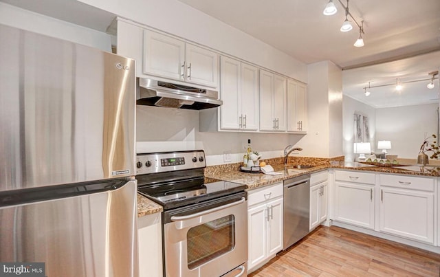 927 S Rolfe St Unit 2, Arlington, VA 22204 - kitchen featuring stainless steel appliances, under cabinet range hood, rail lighting, light wood-type flooring, and white cabinets