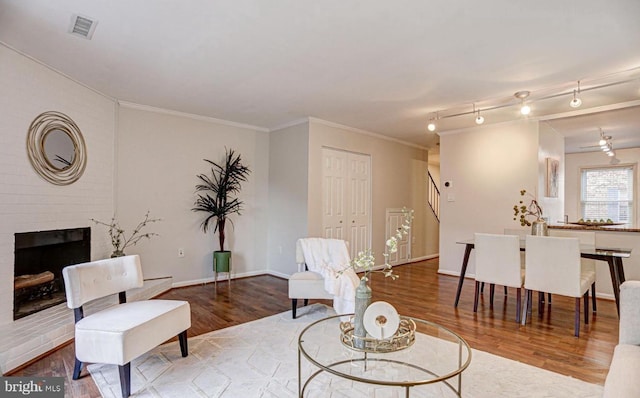 927 S Rolfe St Unit 2, Arlington, VA 22204 - living room featuring stairway, wood finished floors, a fireplace, and crown molding