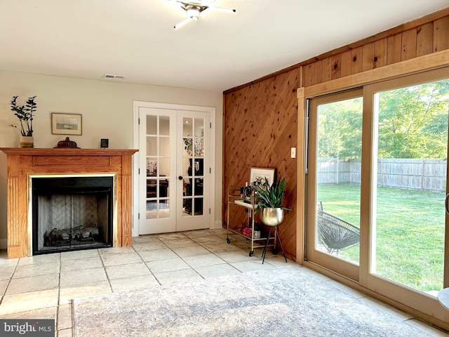17 Haines Dr, Sewell, NJ 08080 - living area with french doors, healthy amount of natural light, wooden walls, tile patterned floors, and a fireplace
