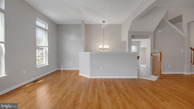 4724 Hanrahan Pl, Alexandria, VA 22309 - empty room featuring a chandelier, healthy amount of natural light, and light wood-style flooring