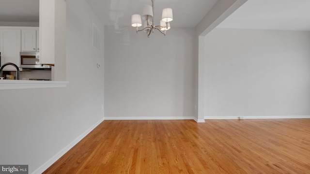 4724 Hanrahan Pl, Alexandria, VA 22309 - unfurnished dining area featuring a chandelier and light wood-style floors