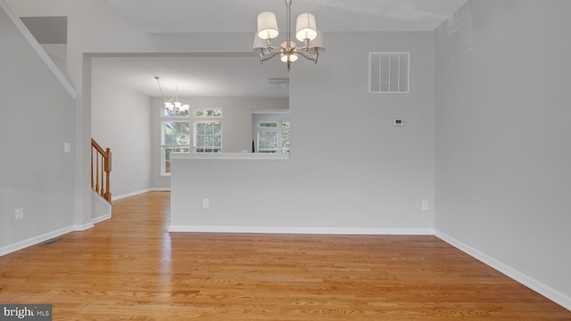 4724 Hanrahan Pl, Alexandria, VA 22309 - spare room featuring a chandelier, light wood-style flooring, and stairway