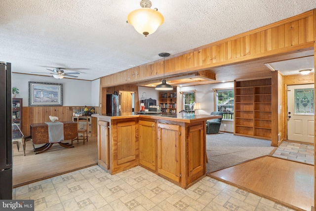 590 Vaught Dr, Front Royal, VA 22630 - kitchen with open floor plan, wood walls, a textured ceiling, a center island, and ceiling fan