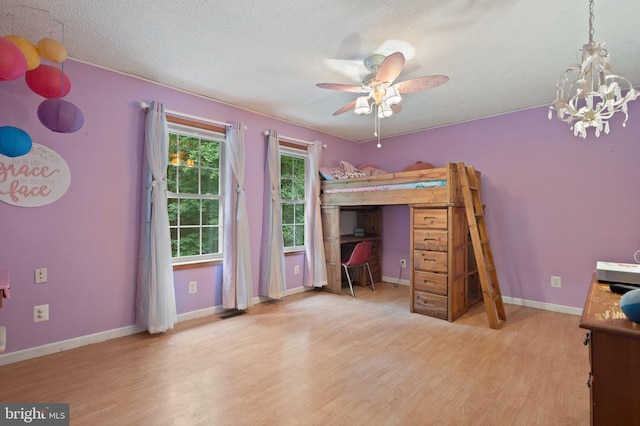 590 Vaught Dr, Front Royal, VA 22630 - bedroom featuring wood finished floors, a textured ceiling, and a chandelier