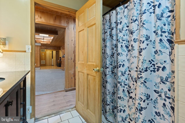 590 Vaught Dr, Front Royal, VA 22630 - bathroom featuring vanity, a shower with curtain, tile patterned flooring, and wood walls