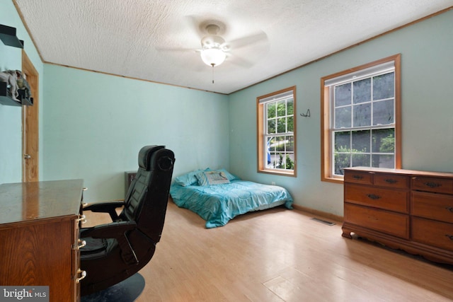 590 Vaught Dr, Front Royal, VA 22630 - bedroom with light wood finished floors, a textured ceiling, a desk, and a ceiling fan
