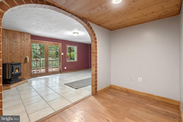 590 Vaught Dr, Front Royal, VA 22630 - unfurnished living room with arched walkways, a wood stove, wood finished floors, and wood ceiling