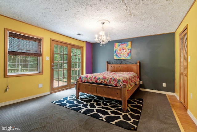 590 Vaught Dr, Front Royal, VA 22630 - bedroom featuring access to exterior, a chandelier, carpet, and a textured ceiling