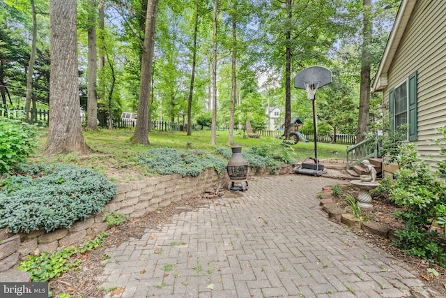 590 Vaught Dr, Front Royal, VA 22630 - fenced backyard with a playground, a patio area, and view of scattered trees