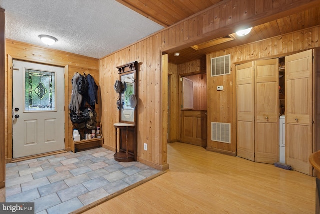 590 Vaught Dr, Front Royal, VA 22630 - foyer with wooden walls, light wood-type flooring, and washer / dryer