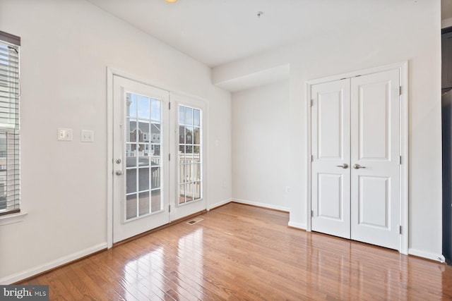 19503 Vaughn Landing Dr, Germantown, MD 20874 - unfurnished bedroom with access to exterior, wood finished floors, and a closet