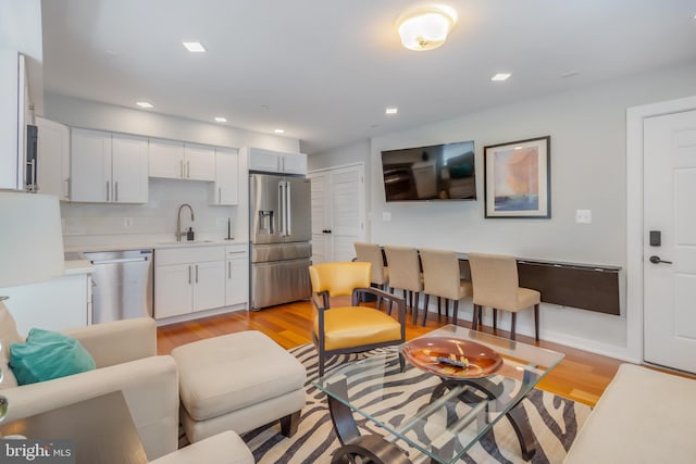 4106 Gault Pl NE Unit 3, Washington, DC 20019 - living area with light wood finished floors and recessed lighting