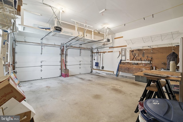 26 Fountain View Dr, Barnegat, NJ 08005 - garage featuring a garage door opener and a workshop area