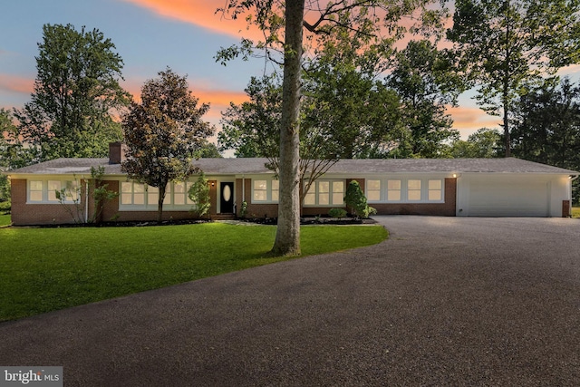 708 E Seminary, Towson, MD 21286 - single story home with asphalt driveway, brick siding, a lawn, a garage, and a chimney