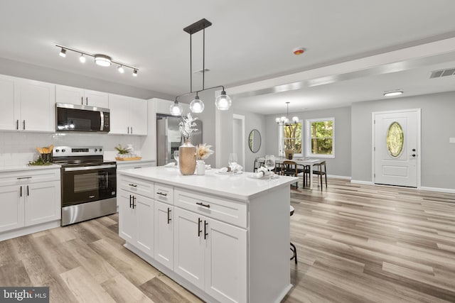 708 E Seminary, Towson, MD 21286 - kitchen with stainless steel appliances, white cabinetry, and backsplash