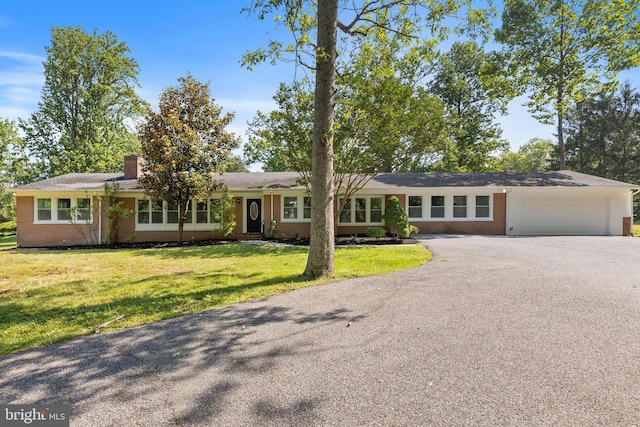 708 E Seminary, Towson, MD 21286 - ranch-style home featuring brick siding, driveway, a garage, a front yard, and a chimney