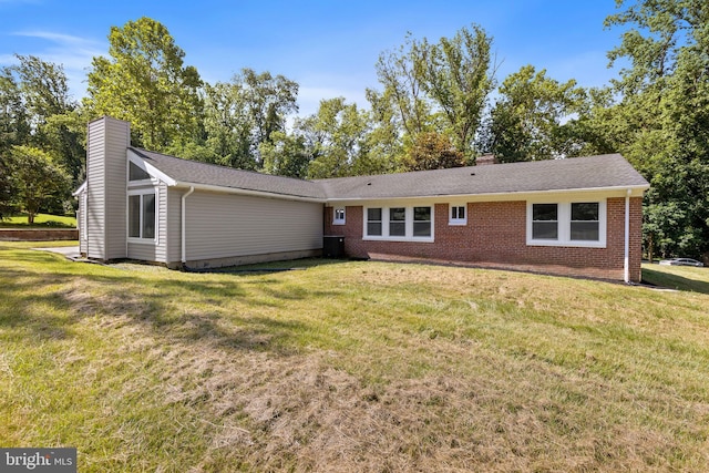 708 E Seminary, Towson, MD 21286 - view of front of property with a chimney, brick siding, a front lawn, and roof with shingles