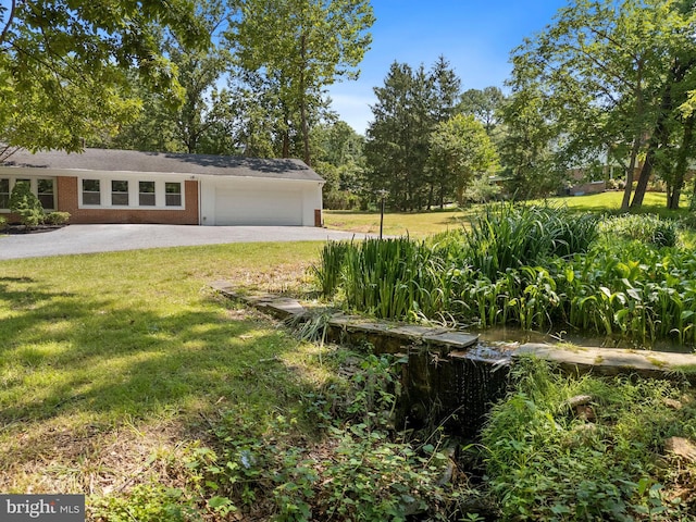 708 E Seminary, Towson, MD 21286 - view of grassy yard featuring a garage and driveway