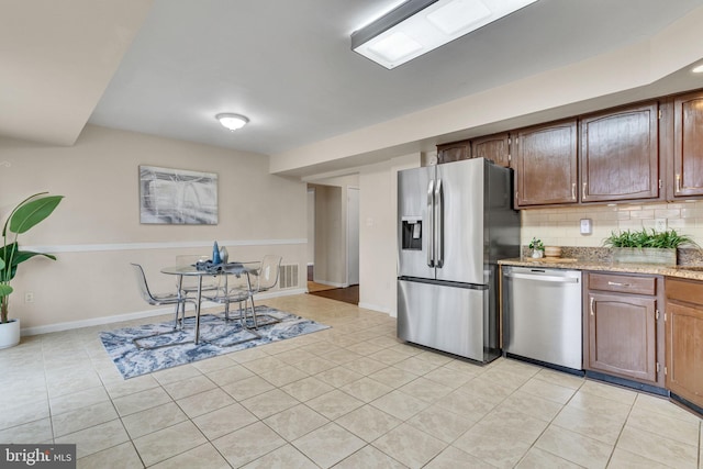 9216 Spring Acres Rd, Clinton, MD 20735 - kitchen featuring stainless steel appliances, tasteful backsplash, light tile patterned floors, and light stone counters
