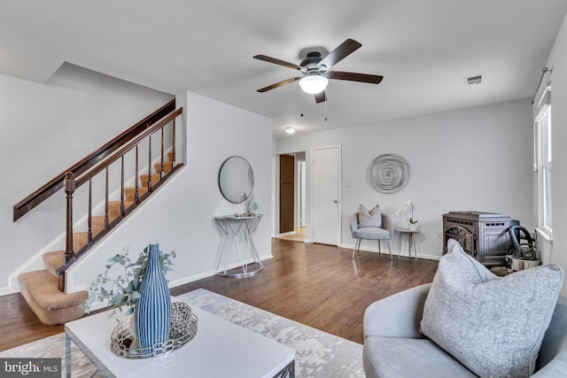 9216 Spring Acres Rd, Clinton, MD 20735 - living area featuring wood finished floors, stairs, ceiling fan, and a wood stove