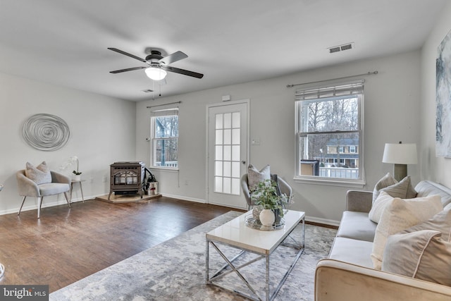 9216 Spring Acres Rd, Clinton, MD 20735 - living area with a wood stove, wood finished floors, and ceiling fan