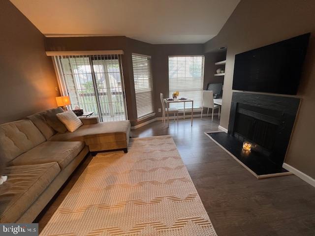 12163 Penderview Ter Unit 1034, Fairfax, VA 22033 - living area featuring plenty of natural light, wood finished floors, a fireplace, and lofted ceiling
