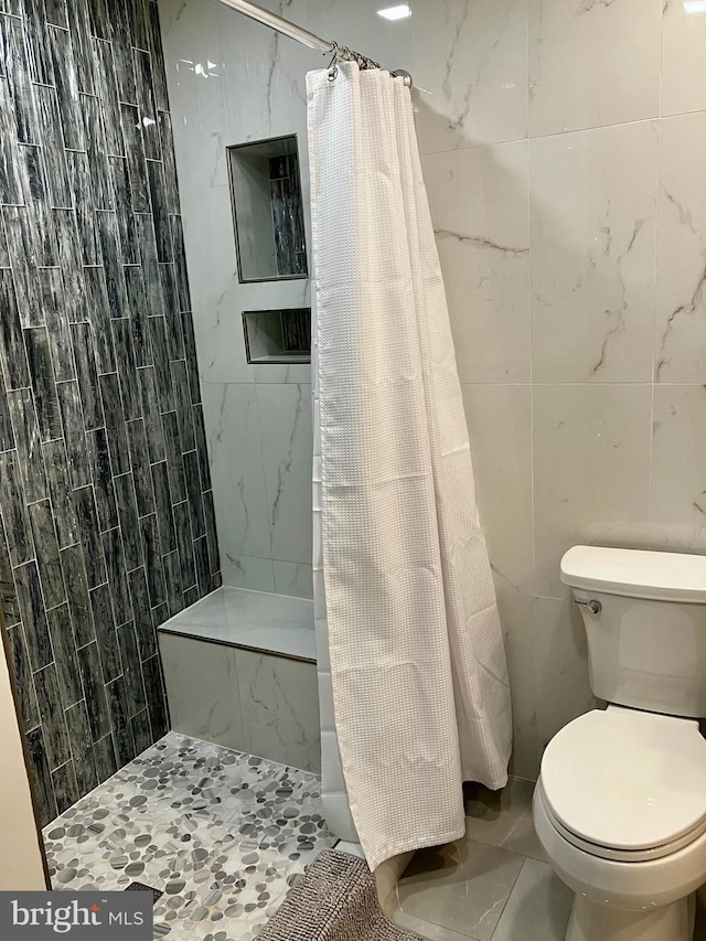 12163 Penderview Ter Unit 1034, Fairfax, VA 22033 - full bathroom featuring tile walls and a tile shower