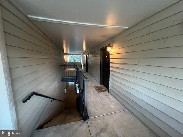 12163 Penderview Ter Unit 1034, Fairfax, VA 22033 - stairway featuring wooden walls and unfinished concrete flooring