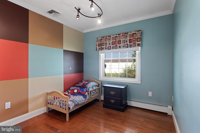 25 Tulip Ln, Levittown, PA 19054 - bedroom featuring a baseboard heating unit, wood finished floors, ornamental molding, and track lighting