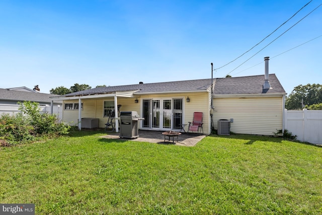 25 Tulip Ln, Levittown, PA 19054 - rear view of house featuring a fire pit, a patio, and roof with shingles