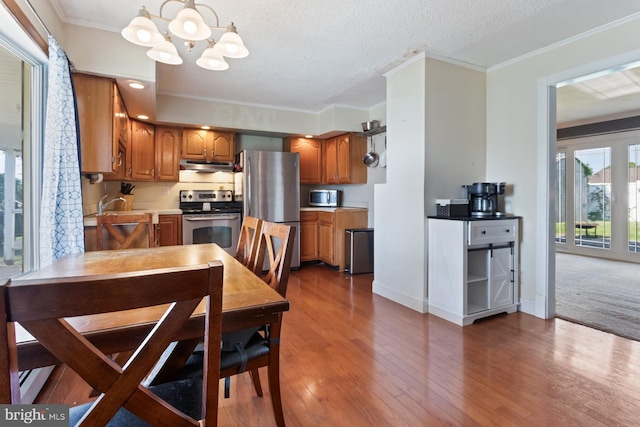 25 Tulip Ln, Levittown, PA 19054 - dining area with a chandelier, wood finished floors, and crown molding